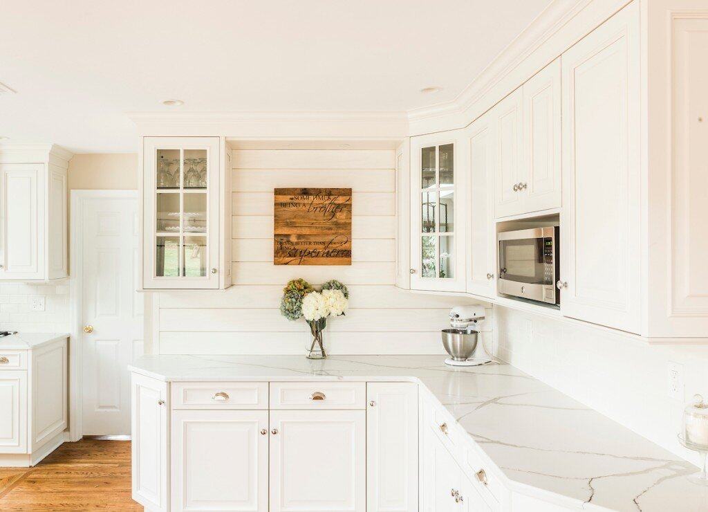 White shiplap kitchen with quartz countertops and glass-front cabinets in Paoli, PA by Fedor Fabrication
