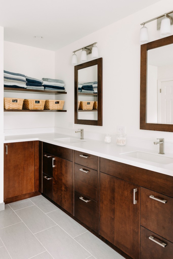 Rain shower head and handheld combo in Ardmore, PA bathroom remodel — Walnut Shaker double vanity, Corian countertops, glass shower