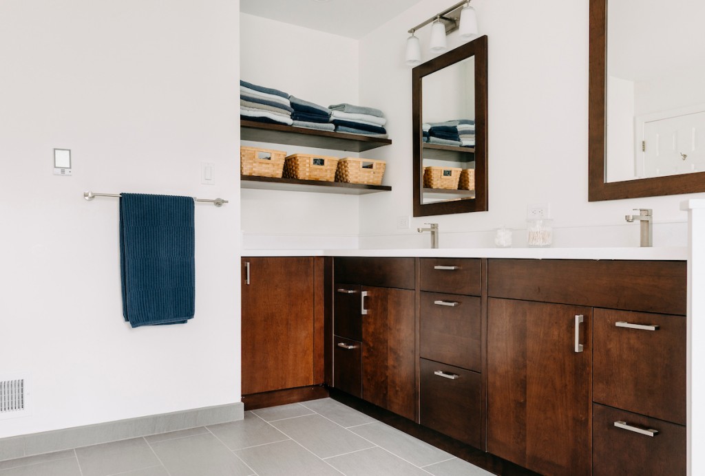 Maple Shaker cabinetry double vanity with white quartz and frameless glass shower in Ardmore, PA — bathroom remodel by Fedor Fabrication