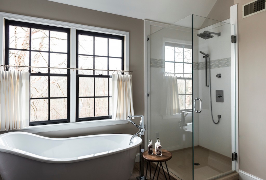 Frameless glass shower with rain head and handheld in Berwyn, PA bathroom remodel — Espresso inset Shaker double vanity, Corian