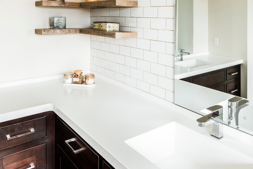 White quartz countertop and undermount sink vignette in Berwyn, PA bathroom remodel — Espresso inset Shaker double vanity, Corian