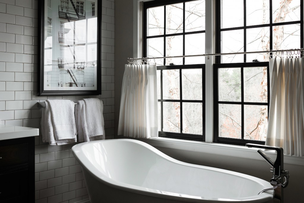 White slipper-style freestanding tub in Berwyn, PA bathroom remodel — Espresso inset Shaker double vanity, Corian