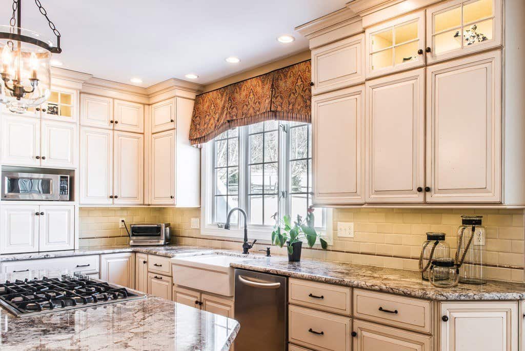 Farmhouse Sink in Berwyn, PA kitchen remodel — Cream raised-panel cabinetry