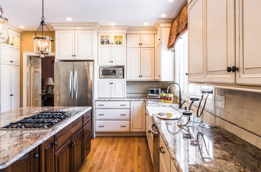 Galley Cooktop in Berwyn, PA kitchen remodel — Cream raised-panel cabinetry