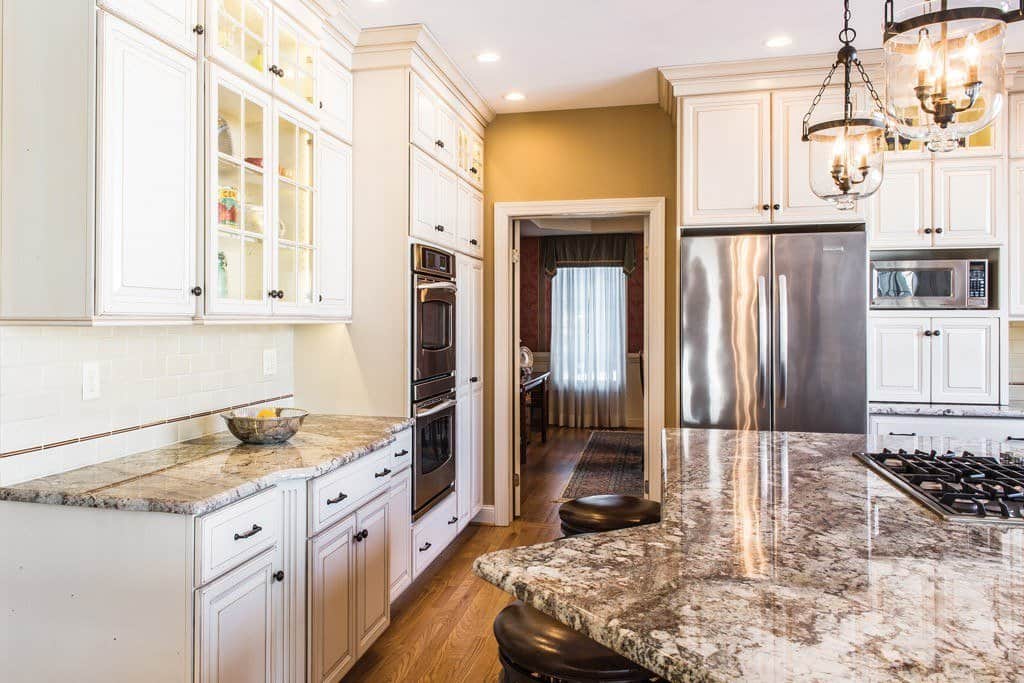 Granite Counters in Berwyn, PA kitchen remodel — Cream raised-panel cabinetry