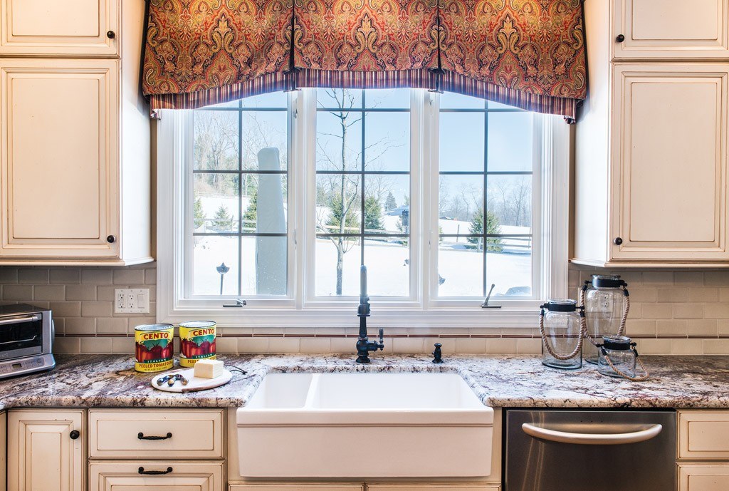 Window Sink in Berwyn, PA kitchen remodel — Cream raised-panel cabinetry