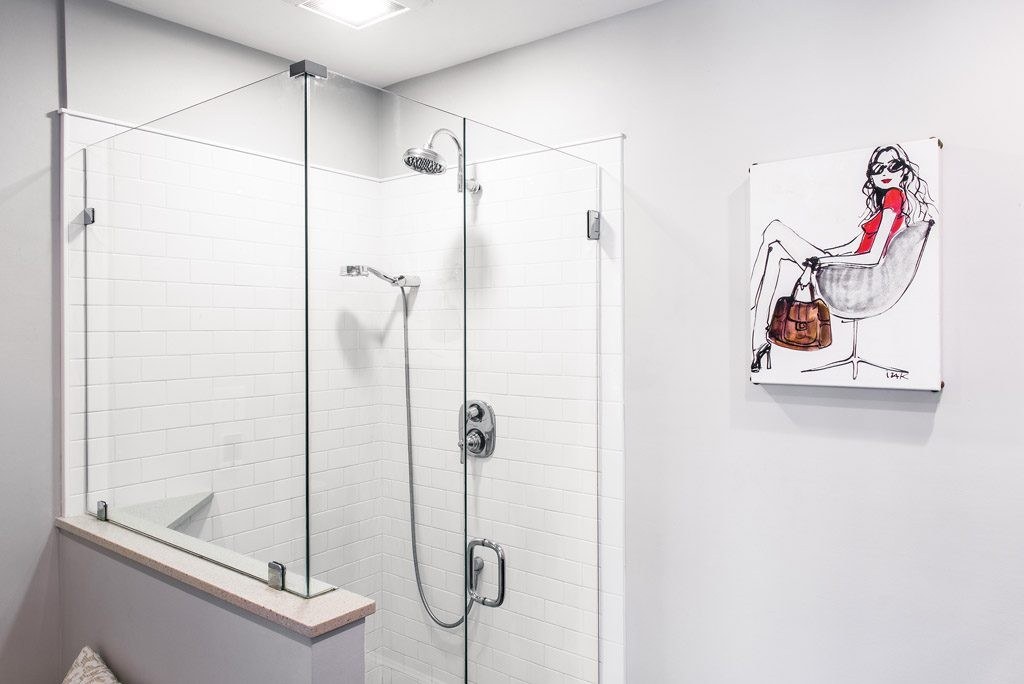 Chester Springs bathroom walk-in shower with frameless glass enclosure, white Corian shower walls, rain shower head and handheld