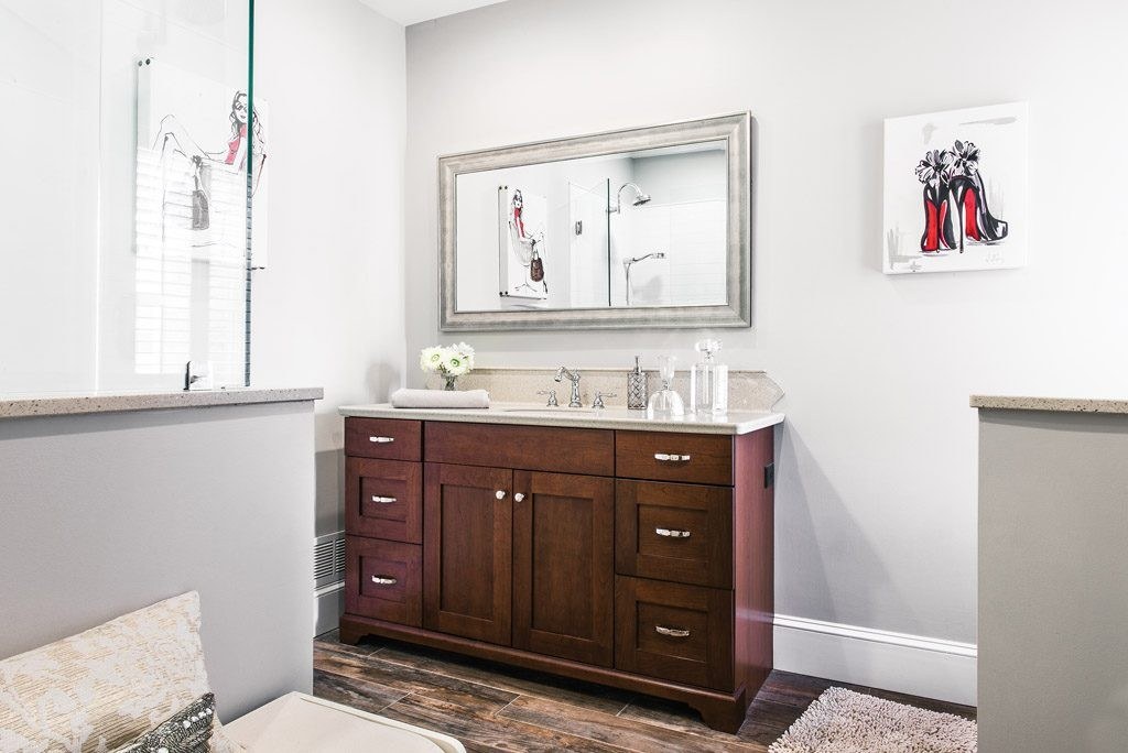 Chester Springs vanity straight-on view showing stained Shaker drawer fronts, sandstone Corian counter, and silver-leaf mirror
