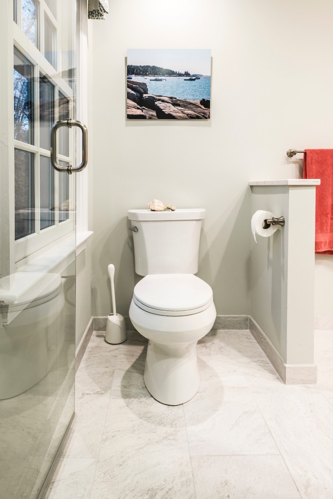 Toilet area in Downingtown, PA bathroom remodel — Cream raised-panel vanity
