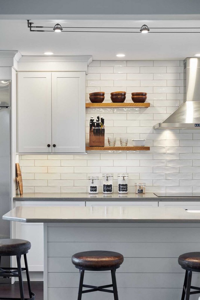 Exton kitchen end view showing the parallel island and built-in stainless refrigerator