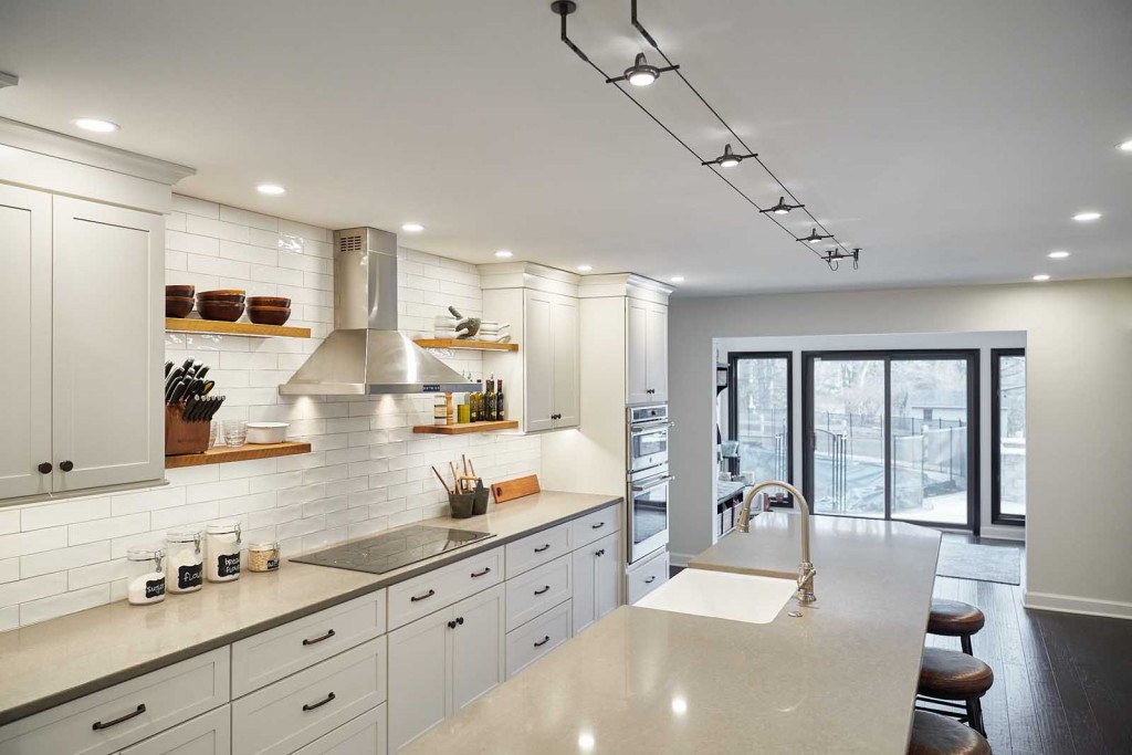 Exton Nordic kitchen island detail showing the fireclay farmhouse sink installed in the island with brushed nickel faucet