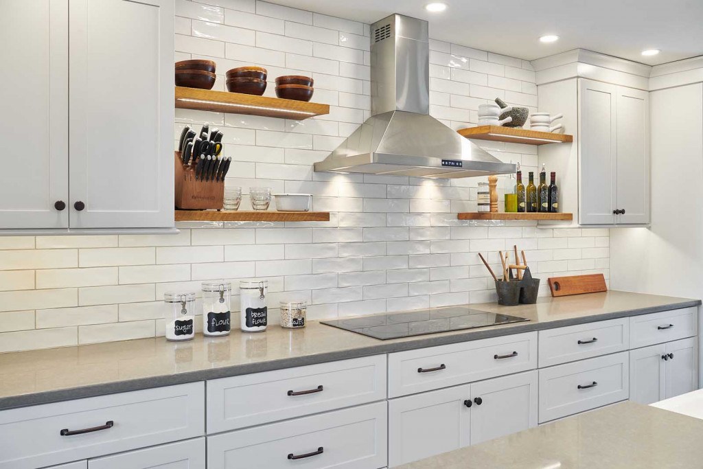 Exton kitchen barn door at the pantry opening with white painted panel and matte black top-hung hardware