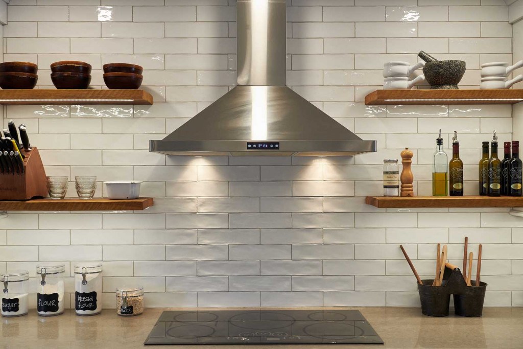 Exton Nordic kitchen showing black-trimmed casement windows above the range run