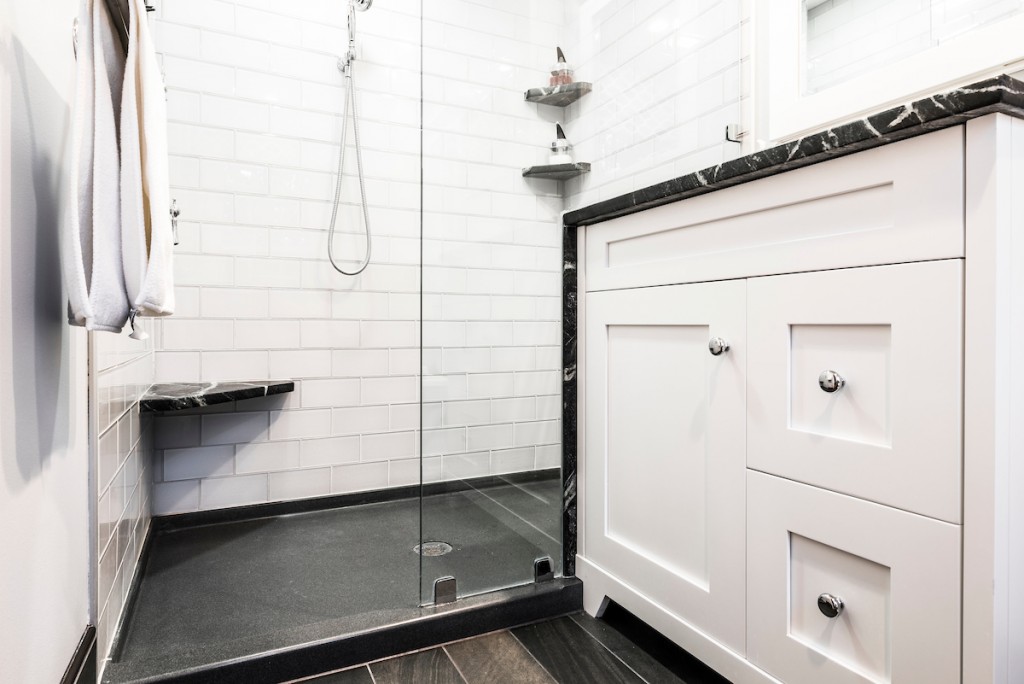 Shower bench in white subway tile shower in Kennett Square, PA bathroom remodel — White Shaker vanity