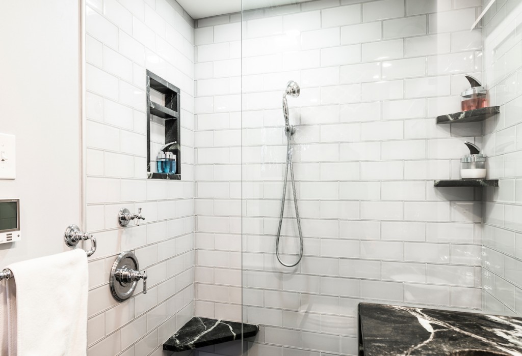 Shower niche with marble bench and corner shelves in Kennett Square, PA bathroom remodel — White Shaker vanity