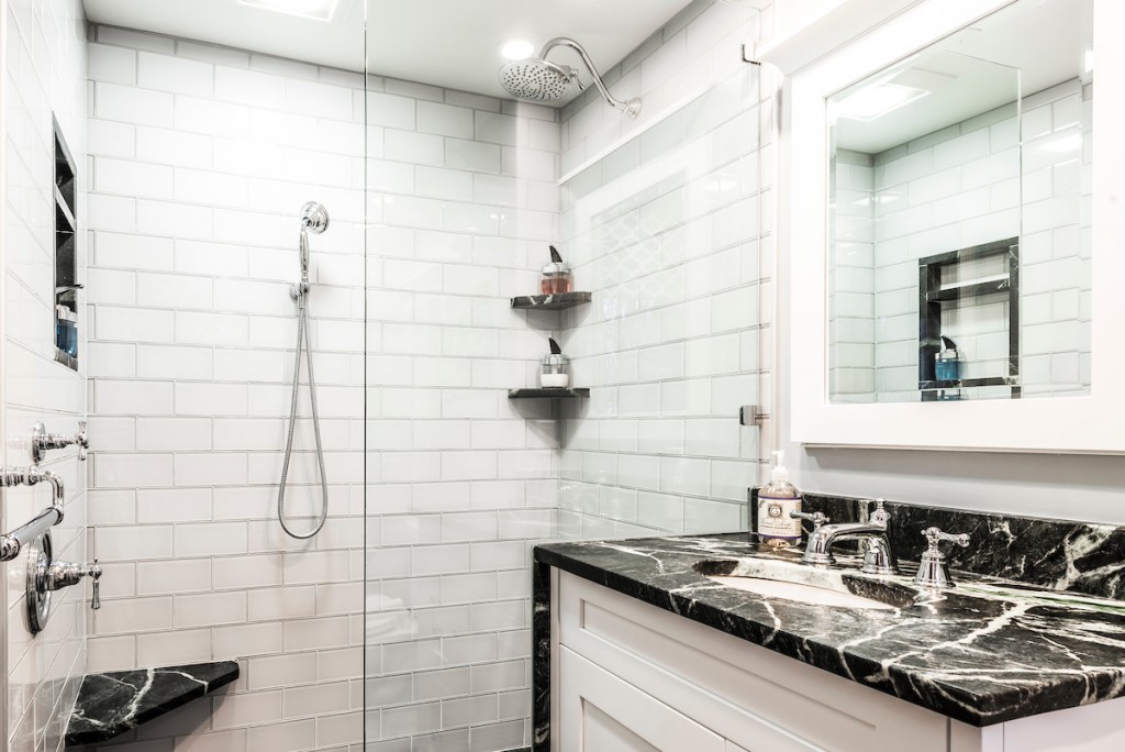 Shower and vanity with white painted Shaker cabinetry in Kennett Square, PA bathroom remodel — White Shaker vanity