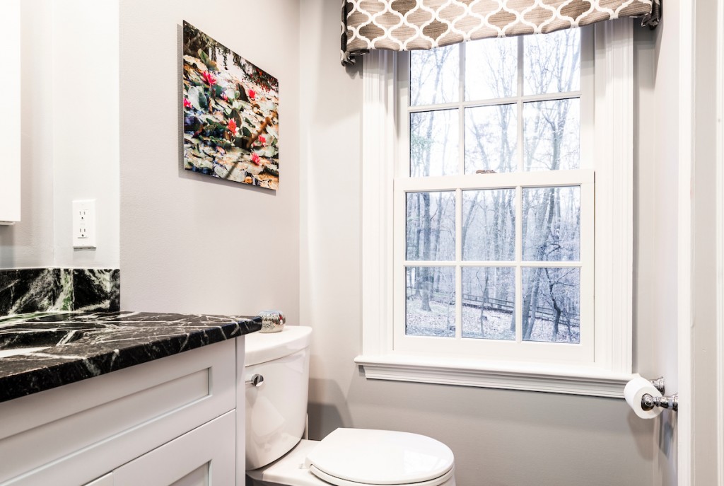 Toilet area with patterned Roman shade in Kennett Square, PA bathroom remodel — White Shaker vanity
