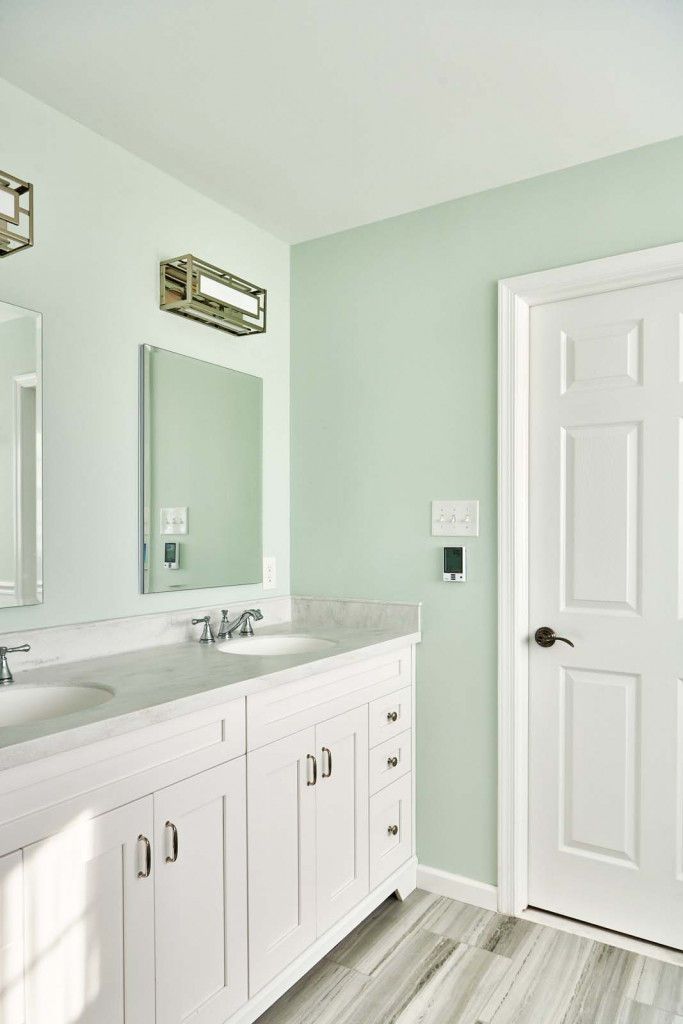 Double vanity with raised-panel wainscot vertical in Malvern, PA bathroom remodel — Mint primary bath