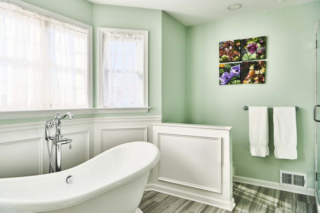 Slipper tub with raised-panel wainscot in Malvern, PA bathroom remodel — Mint primary bath