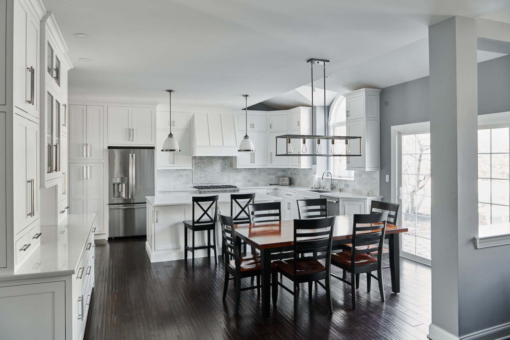 White inset Shaker cabinetry kitchen with caged-bulb chandelier and Carrara subway in Malvern, PA — kitchen remodel by Fedor Fabrication