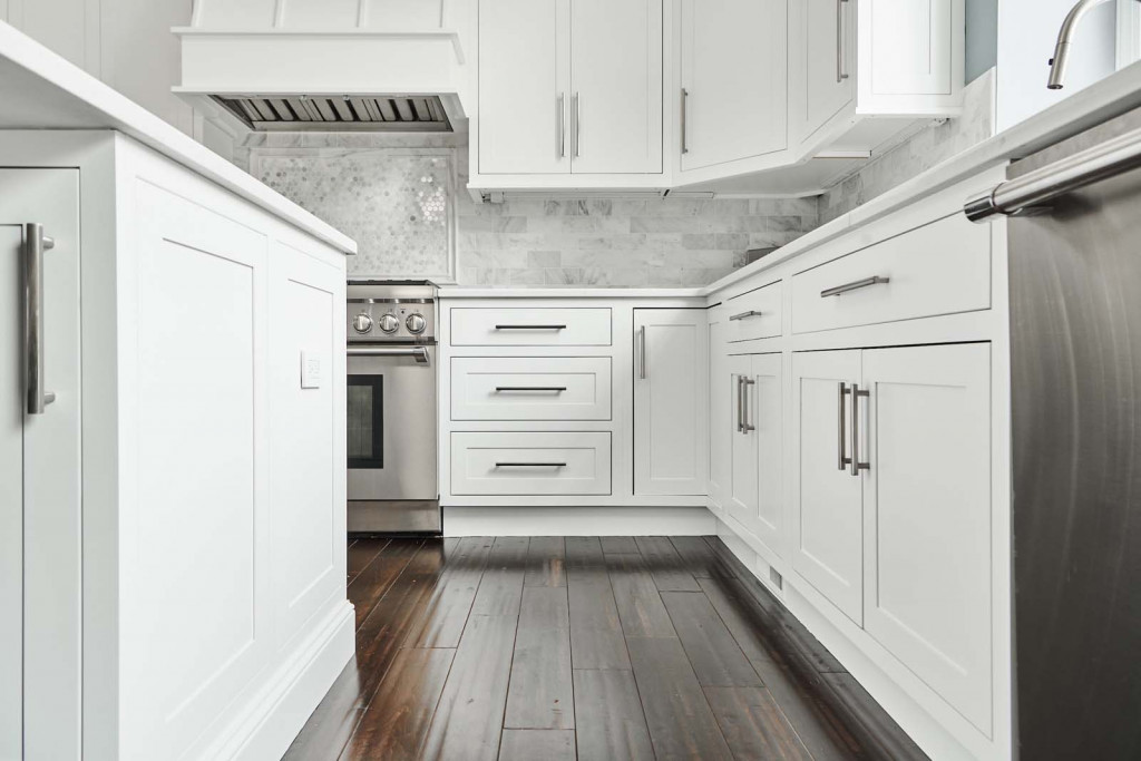 Galley Range in Malvern, PA kitchen remodel — White inset Shaker cabinetry