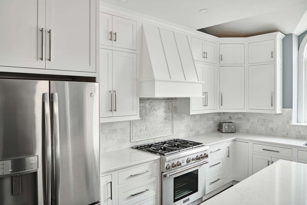 Paneled Hood in Malvern, PA kitchen remodel — White inset Shaker cabinetry