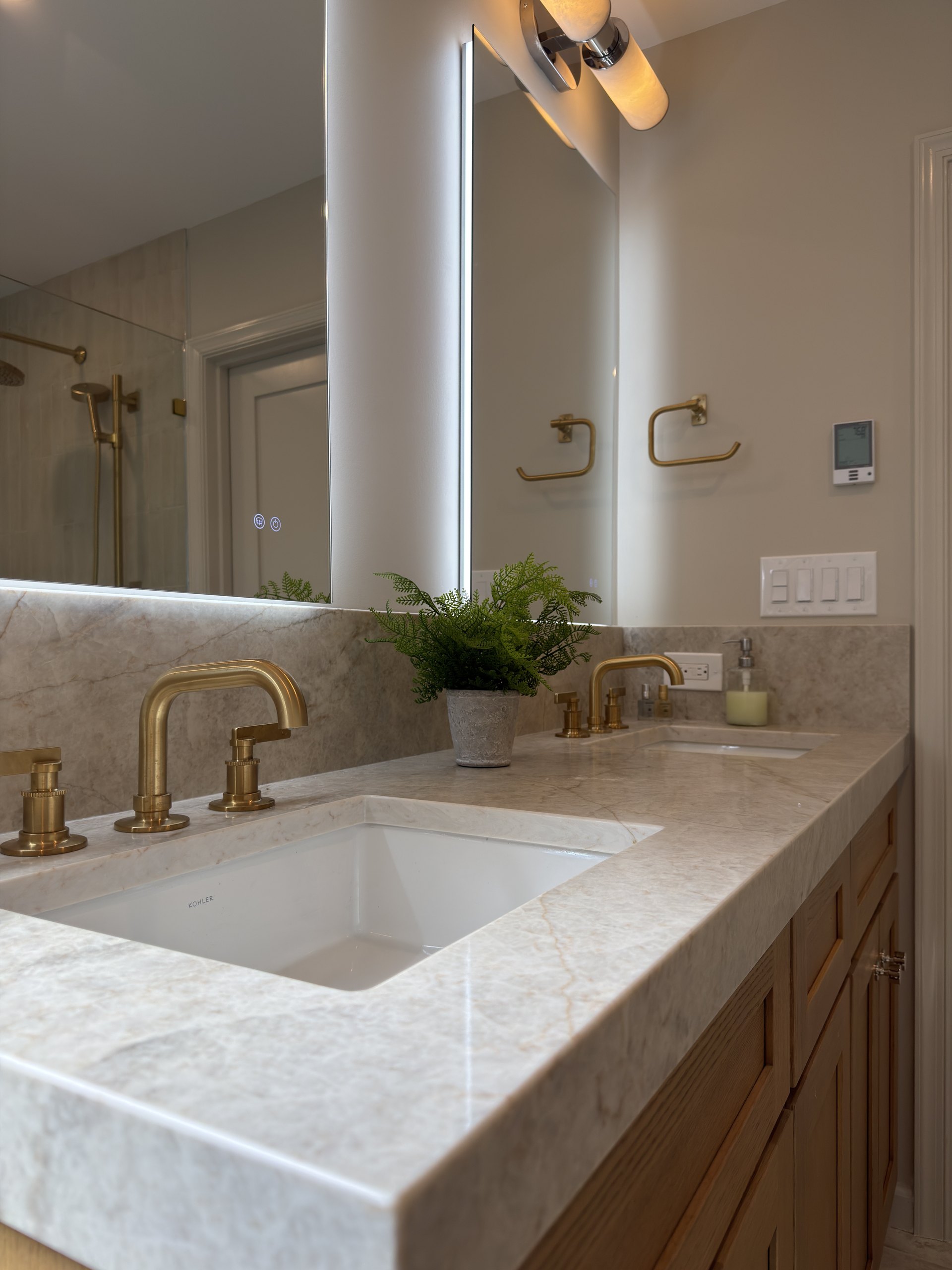 Cosentino ECLOS Tajnar quartz countertop with a brass widespread faucet and undermount sink