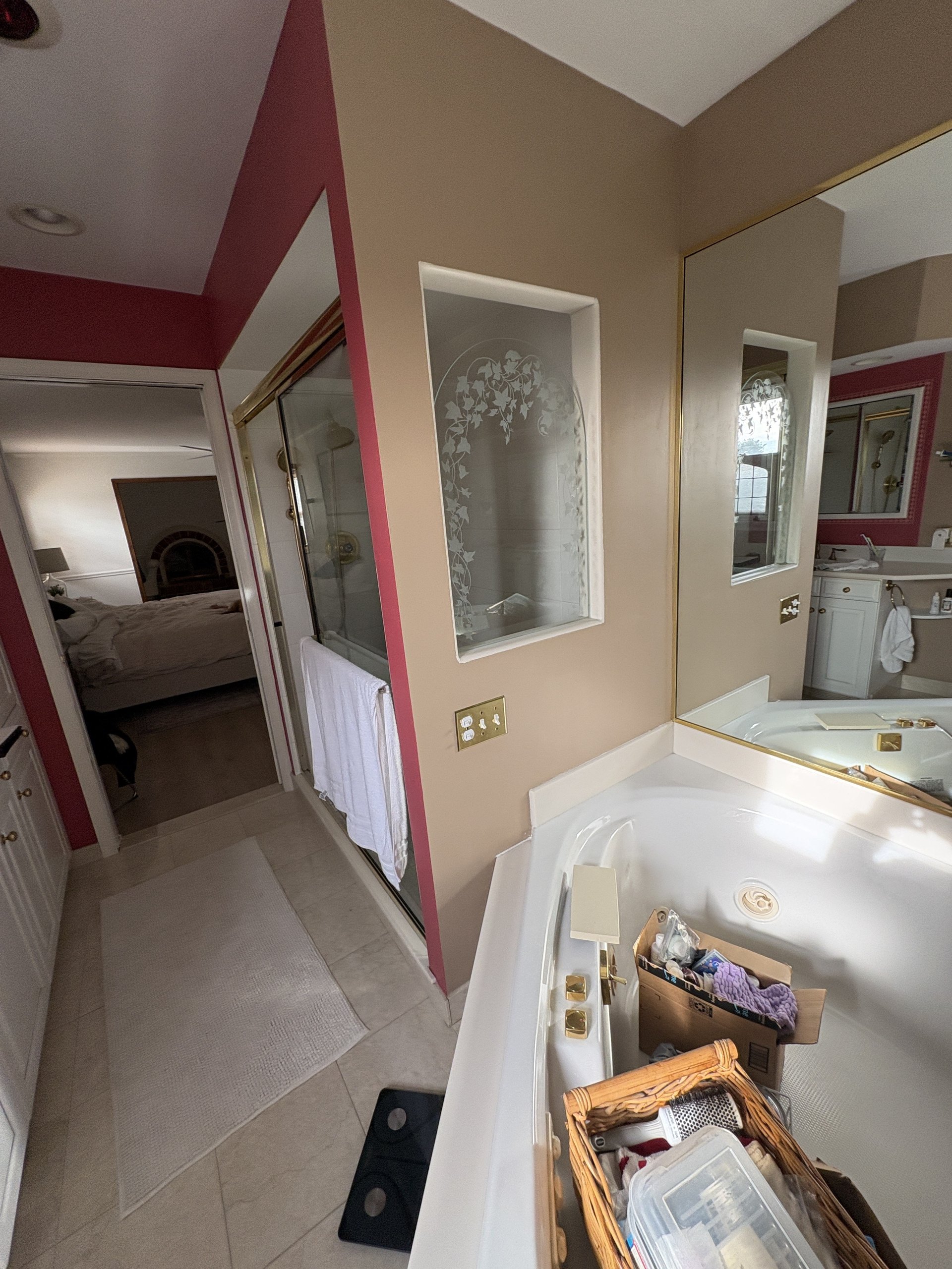 Original drop-in jetted tub, etched-ivy glass niche, and dated corner shower