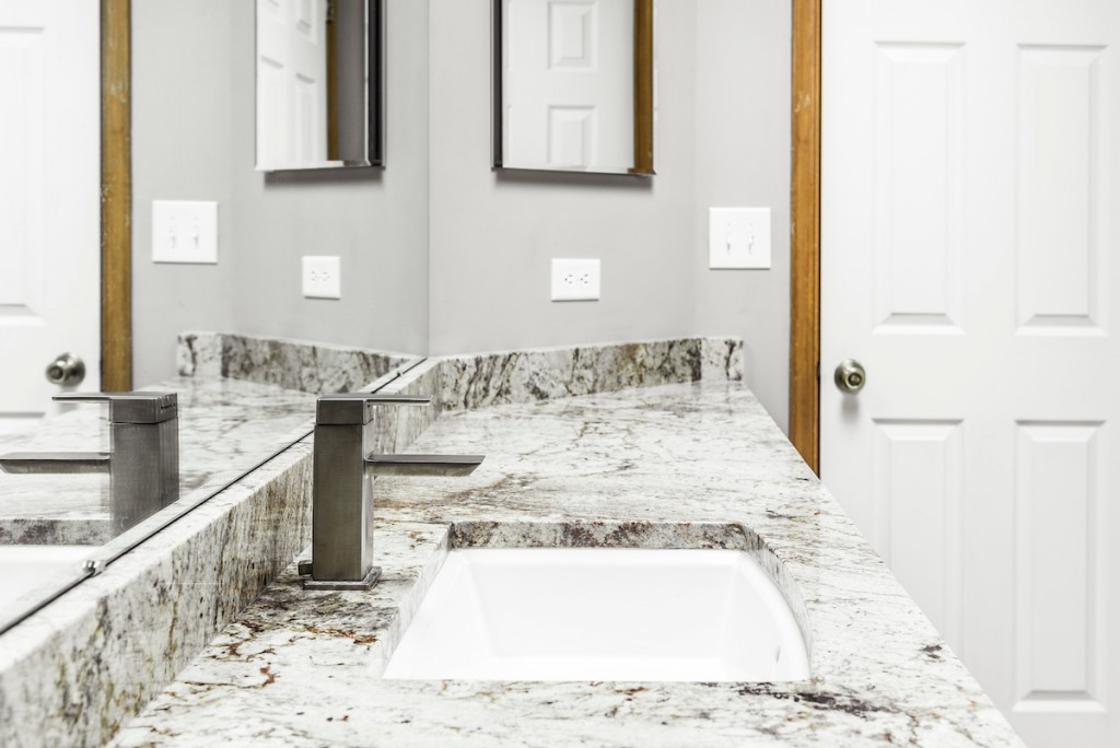 Espresso Shaker cabinetry vanity with veined granite and gray plank tub surround in Media, PA — bathroom remodel by Fedor Fabrication