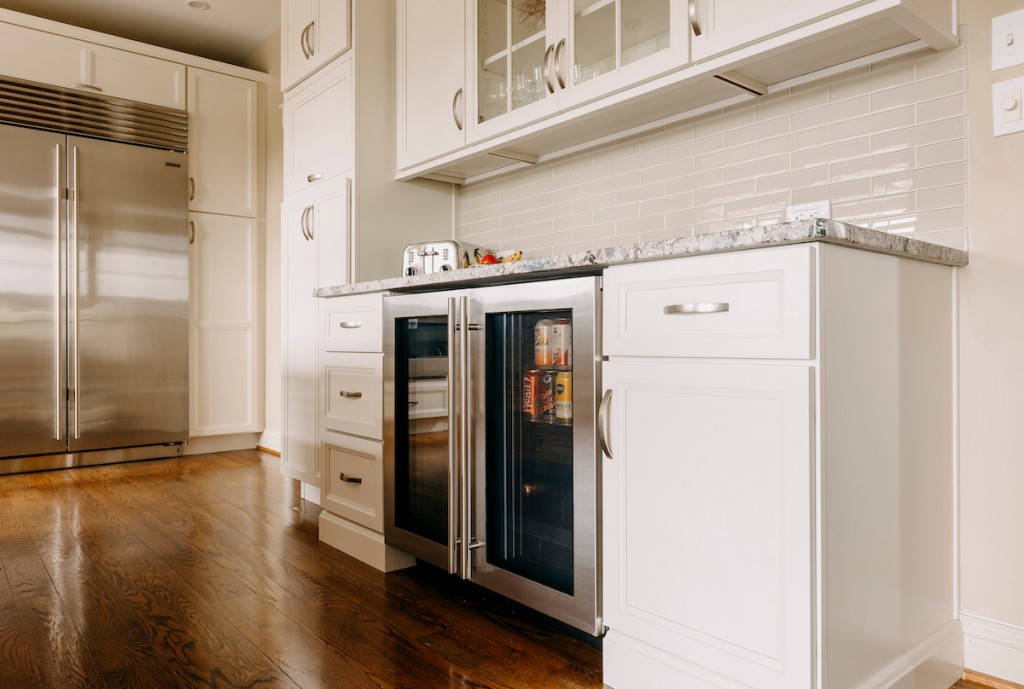 Beverage Fridge in Media, PA kitchen remodel — White recessed-panel cabinetry