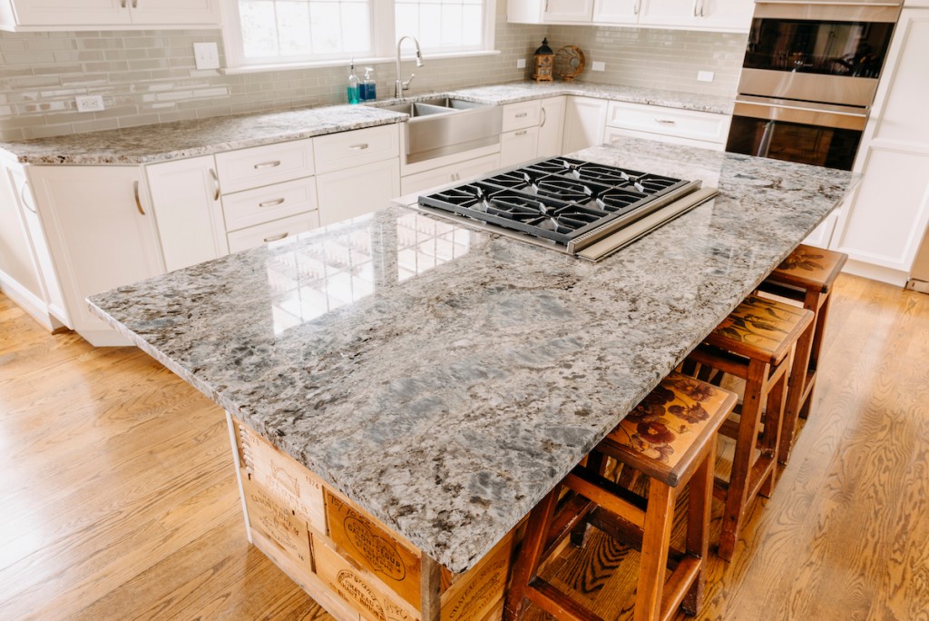 Granite Cooktop in Media, PA kitchen remodel — White recessed-panel cabinetry