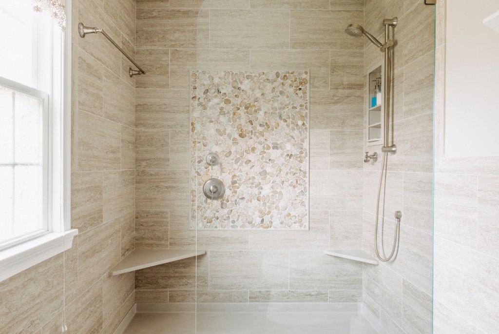 Pebble mosaic focal accent on shower wall in Newtown Square, PA bathroom remodel — Cerused oak raised-panel double vanity