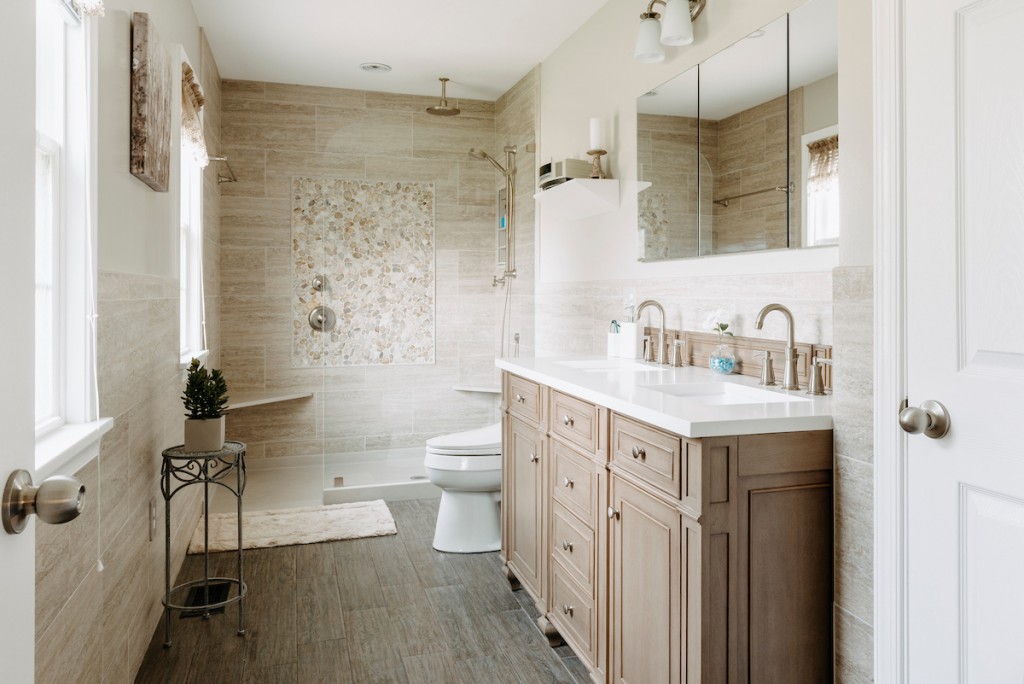 Cerused oak Shaker cabinetry double vanity with pebble-mosaic shower accent and curbless walk-in in Newtown Square, PA — primary bath remodel by Fedor Fabrication