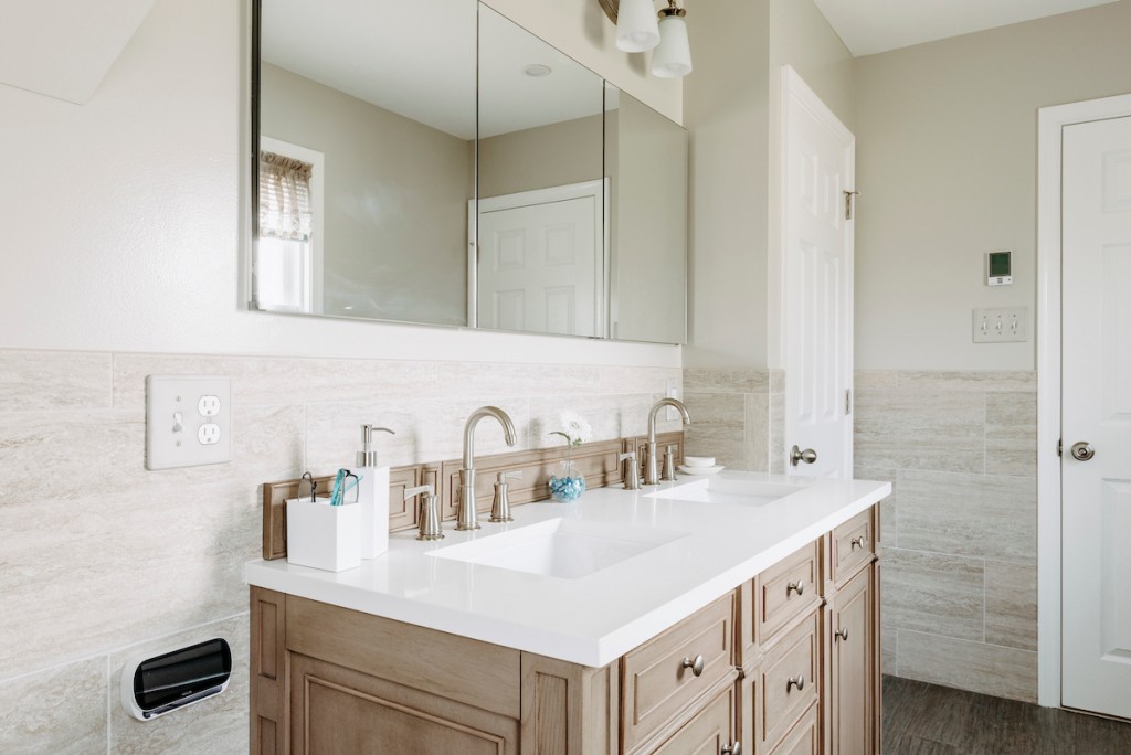 Espresso Shaker vanity with frameless mirror in Newtown Square, PA bathroom remodel — Cerused oak raised-panel double vanity