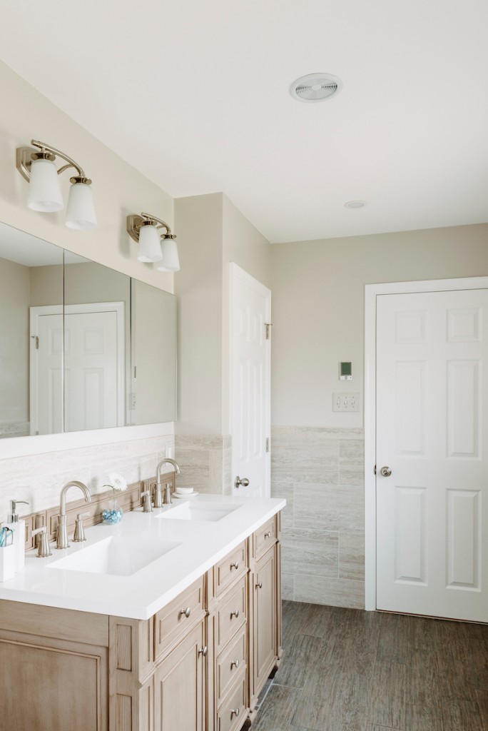 White Shaker double vanity vertical view in attic primary in Newtown Square, PA bathroom remodel — Cerused oak raised-panel double vanity