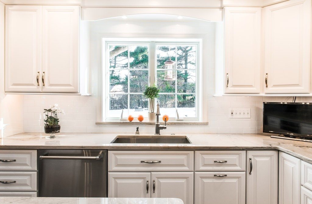 Arched Window in Newtown Square, PA kitchen remodel — Cream raised-panel cabinetry