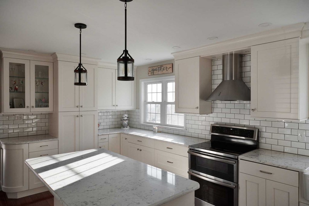 Villanova kitchen view down the perimeter run with white Shaker frameless cabinets and quartz counters