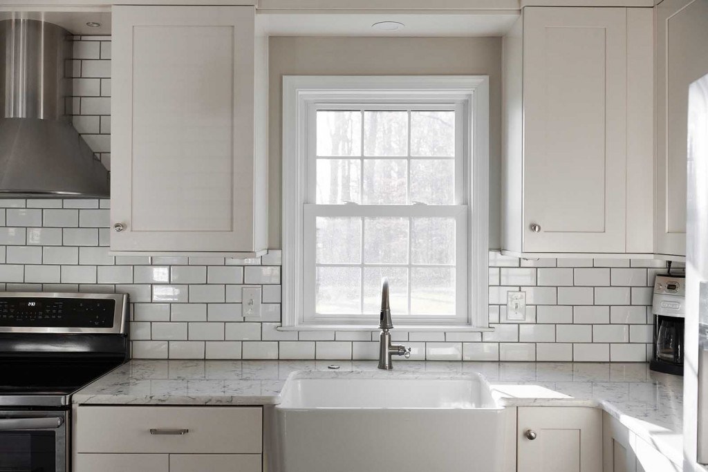 Villanova kitchen looking back at the island with beadboard panel on the seating-side back