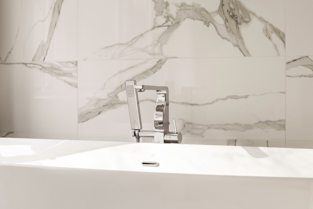 Polished chrome square deck-mount tub filler with handheld in Wayne, PA bathroom remodel — Quiet luxury master bath in Calacatta-look large-slab porcelain