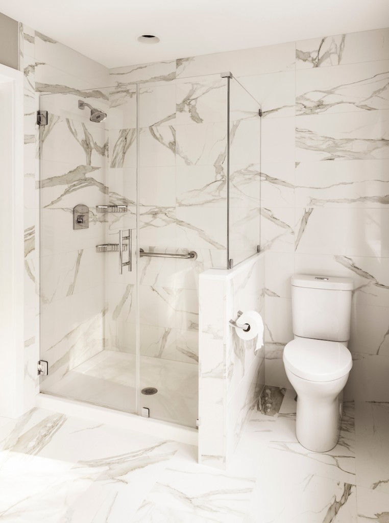 Frameless glass walk-in shower vertical view in Wayne, PA bathroom remodel — Quiet luxury master bath in Calacatta-look large-slab porcelain