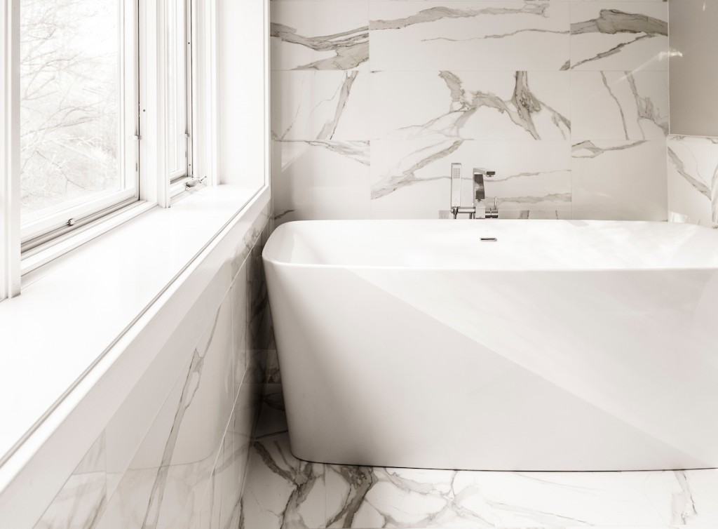 Quiet luxury master bath in Calacatta marble with angular freestanding tub in Wayne, PA — primary bath remodel by Fedor Fabrication