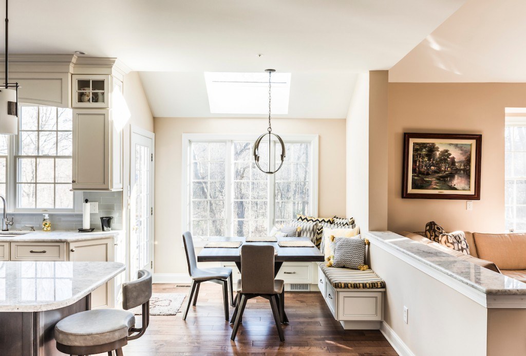 Wayne kitchen detail — granite island edge profile and stacked uppers with glass-fronted transom cabinets