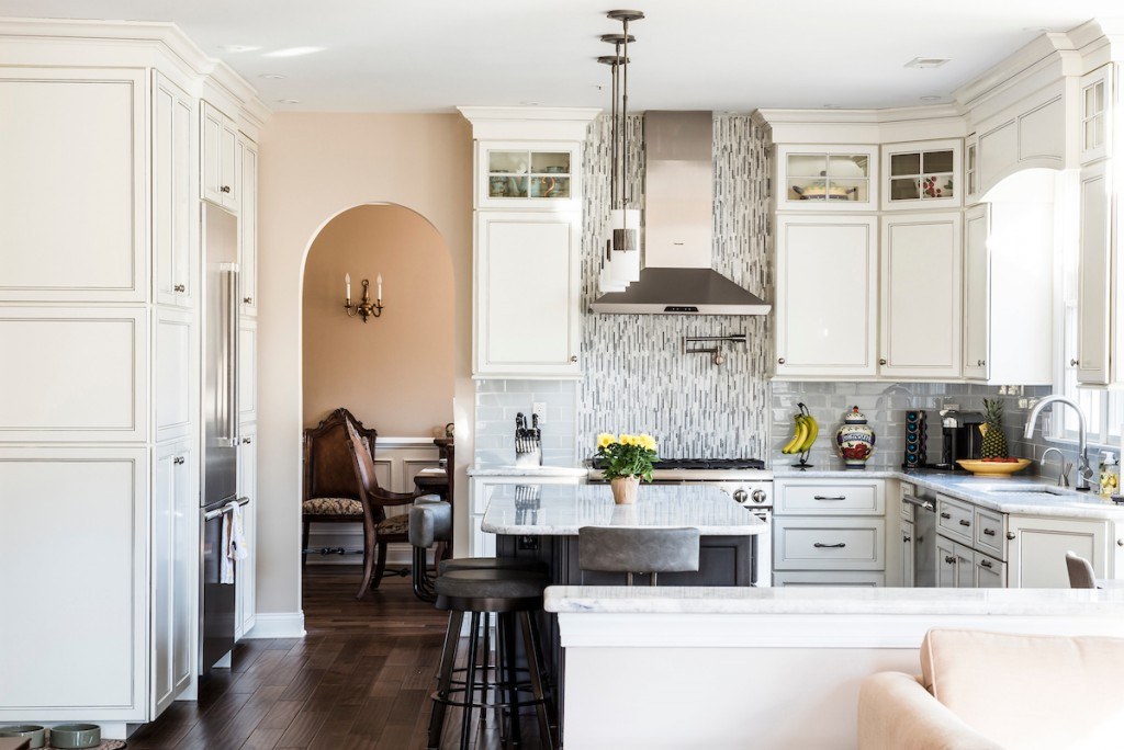 Wayne kitchen view toward the breakfast nook and stone-fireplace great room, hand-scraped hardwood floor running through