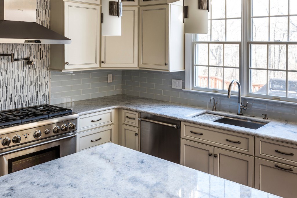 Wayne Toll Brothers kitchen showing sphere chandelier over the breakfast table, cathedral ceiling, and open flow to the great room