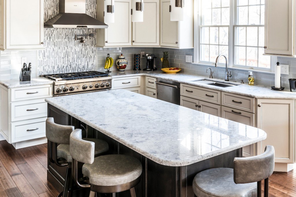 Two-tone Toll Brothers kitchen with cream perimeter cabinets, espresso-stained island, granite counters, and a mosaic accent backsplash in Wayne, PA — kitchen remodel by Fedor Fabrication