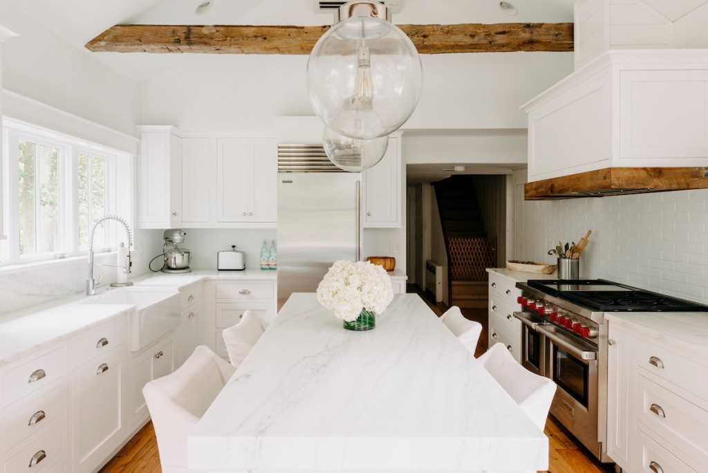 White inset Shaker cabinetry kitchen with reclaimed wood beams and marble dining island in Wayne, PA — kitchen remodel by Fedor Fabrication
