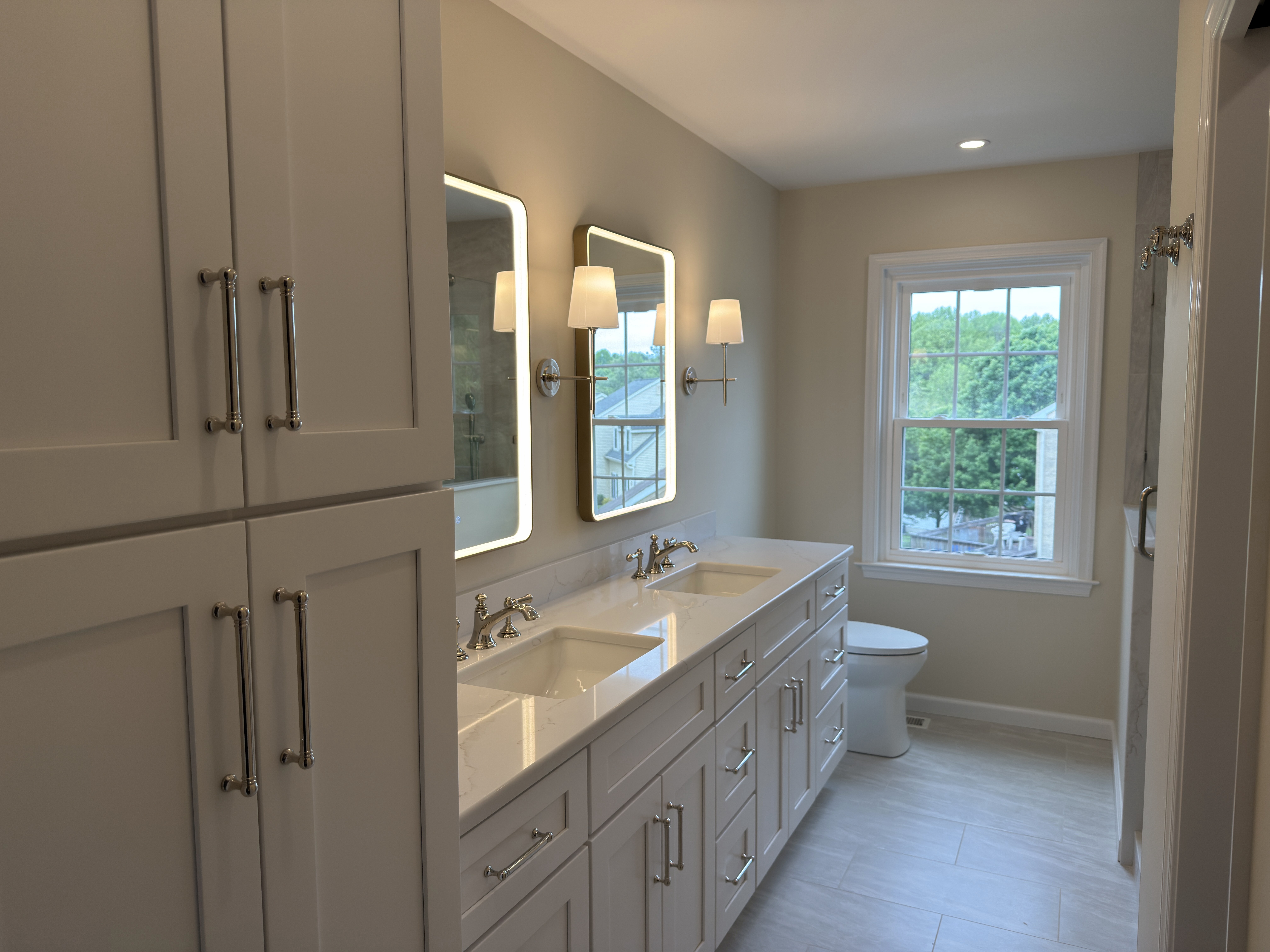 White Tribeca Hudson Snow White double vanity with tall storage cabinet, quartz top, and LED mirrors — Wayne, PA bathroom remodel by Fedor Fabrication