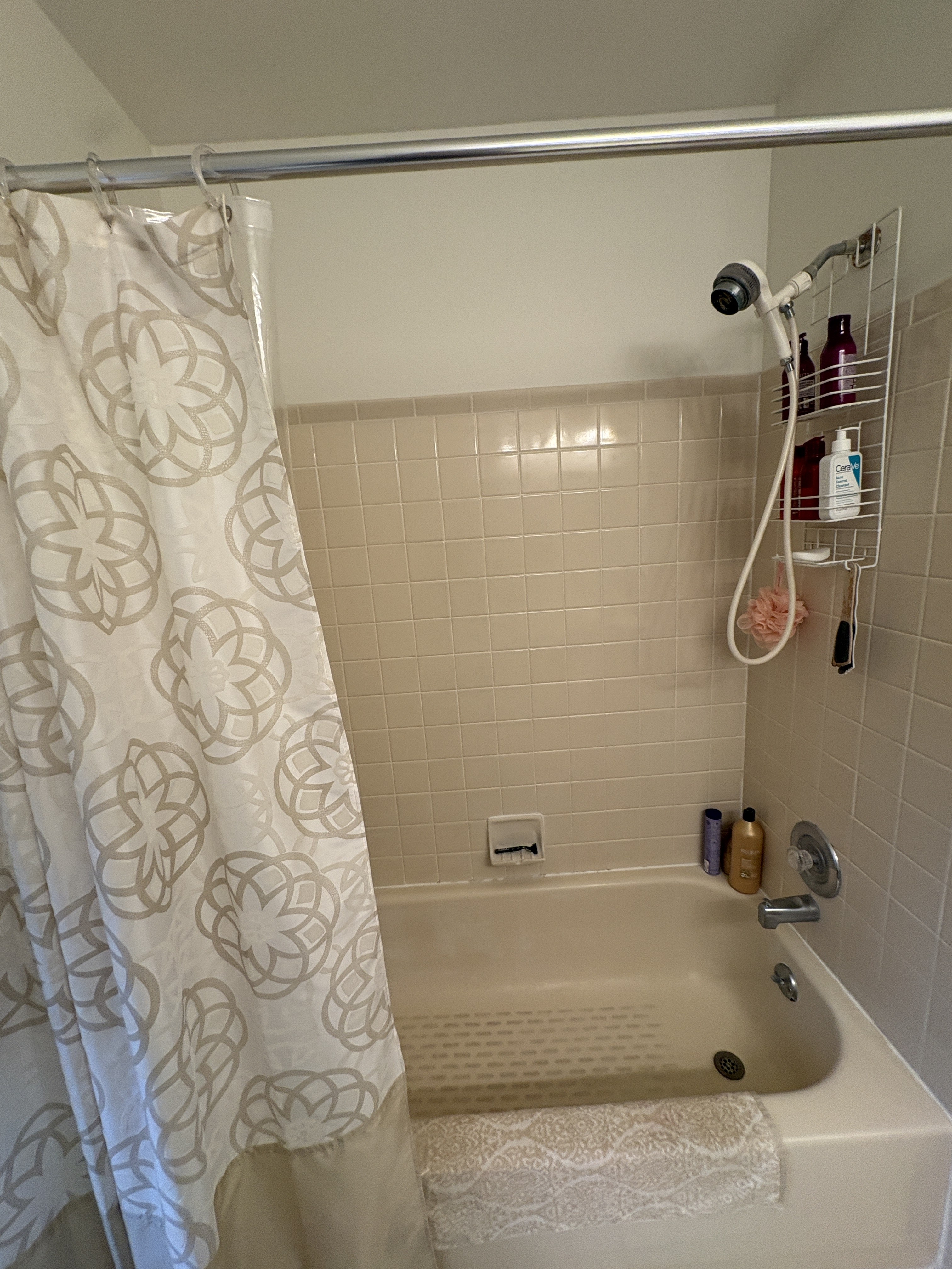 Original tub and white square tile surround before the gut