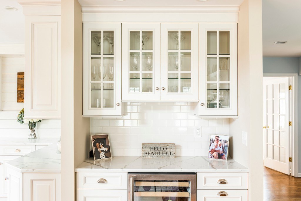 Wayne white country kitchen showing raised-panel cabinets, decorative end panels, and warm red oak hardwood floor