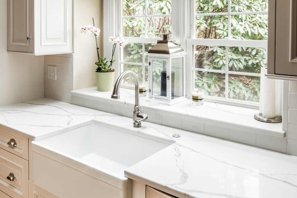Wayne white kitchen wide view with butcher-block island, white perimeter cabinets, and Cambria quartz counters